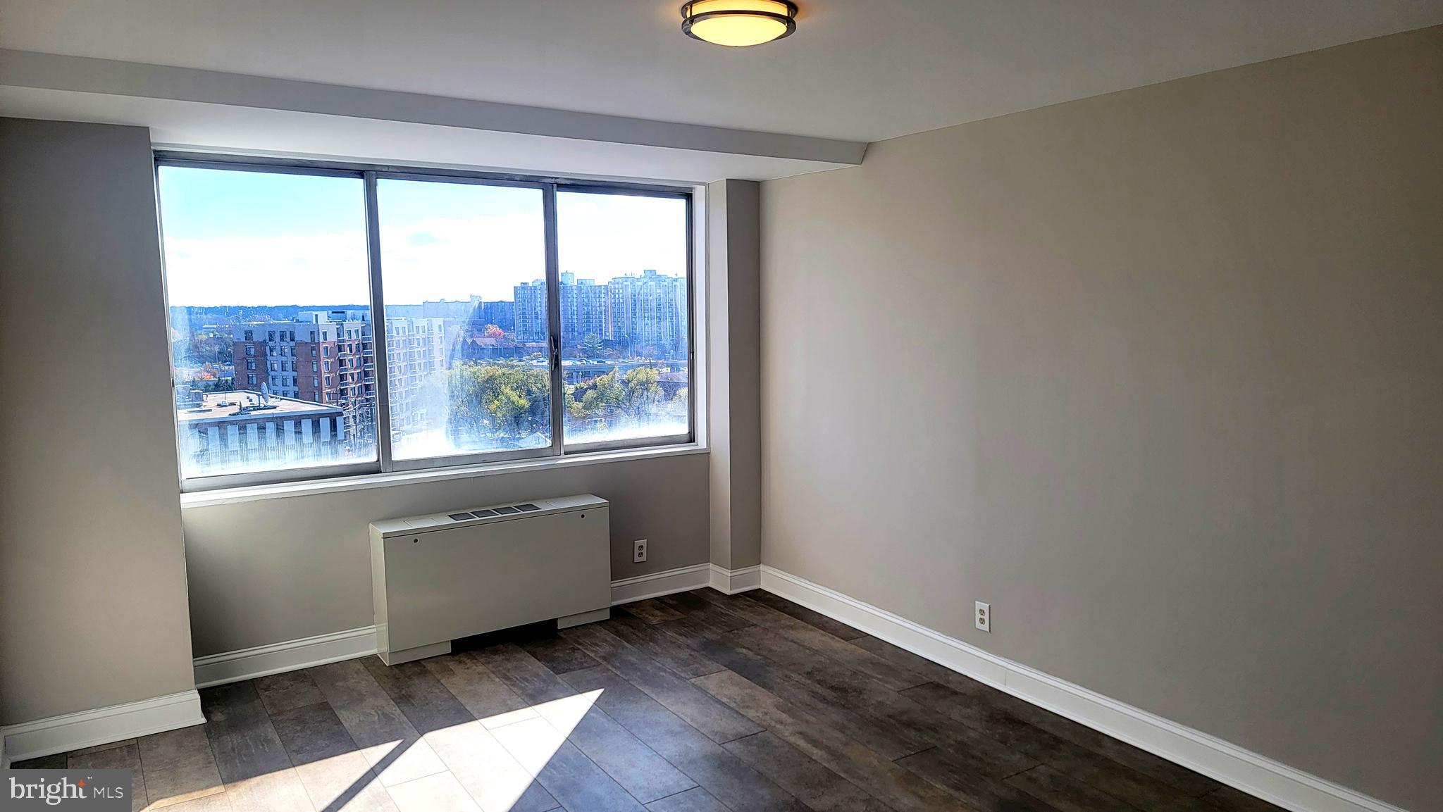 301 North Beauregard Street, Unit 903 Alexandria, VA 22312 - Photo 11 of 19 an empty room with wooden floor and a window