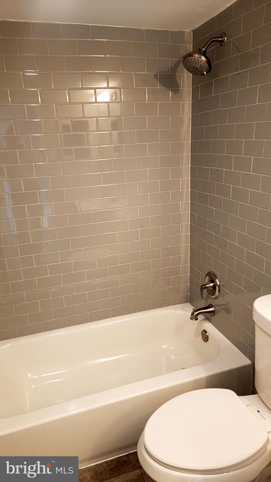 301 North Beauregard Street, Unit 903 Alexandria, VA 22312 - Photo 14 of 19 a bathroom with a toilet and a bath tub