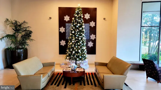 a living room with furniture a table and a potted plant