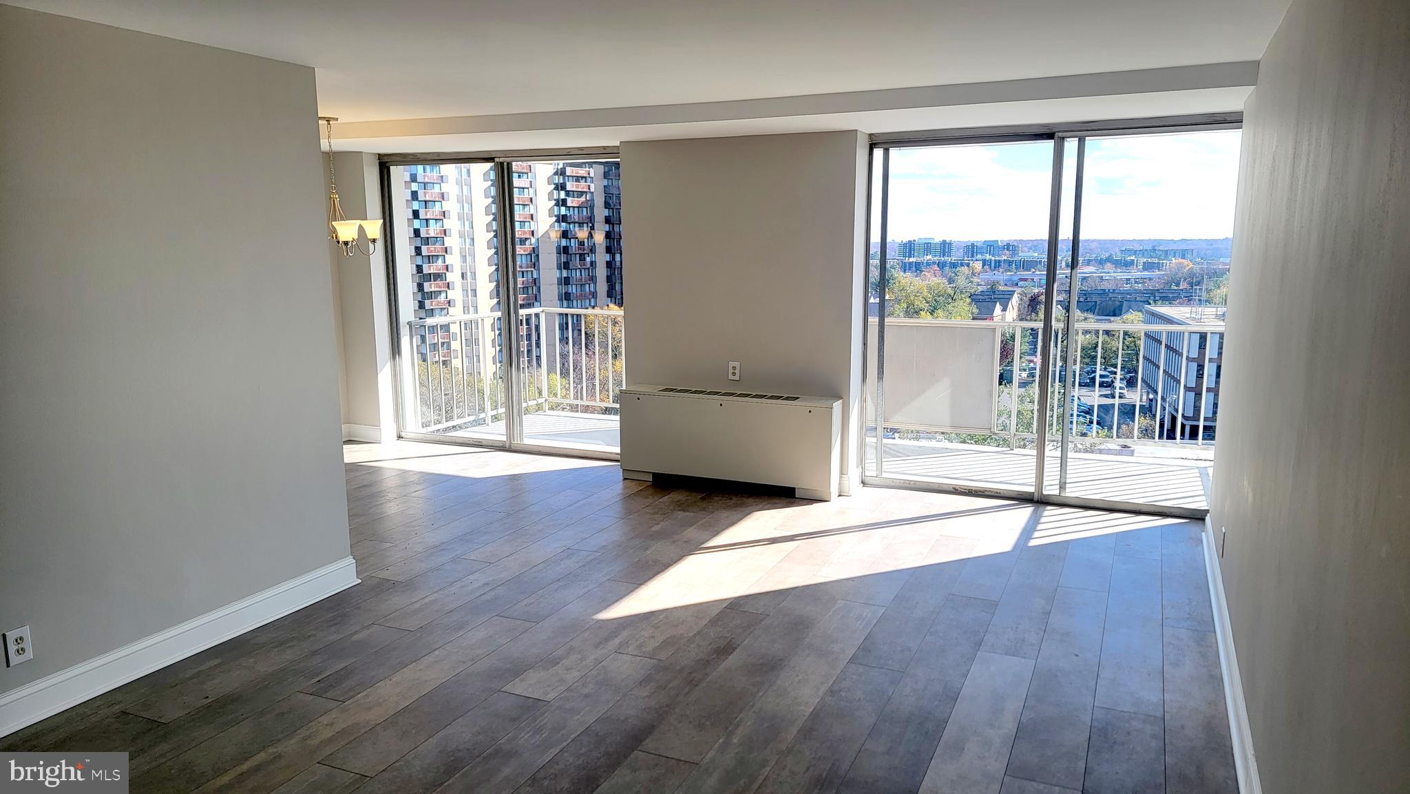 301 North Beauregard Street, Unit 903 Alexandria, VA 22312 - Photo 5 of 19 a view of an empty room with wooden floor and a window