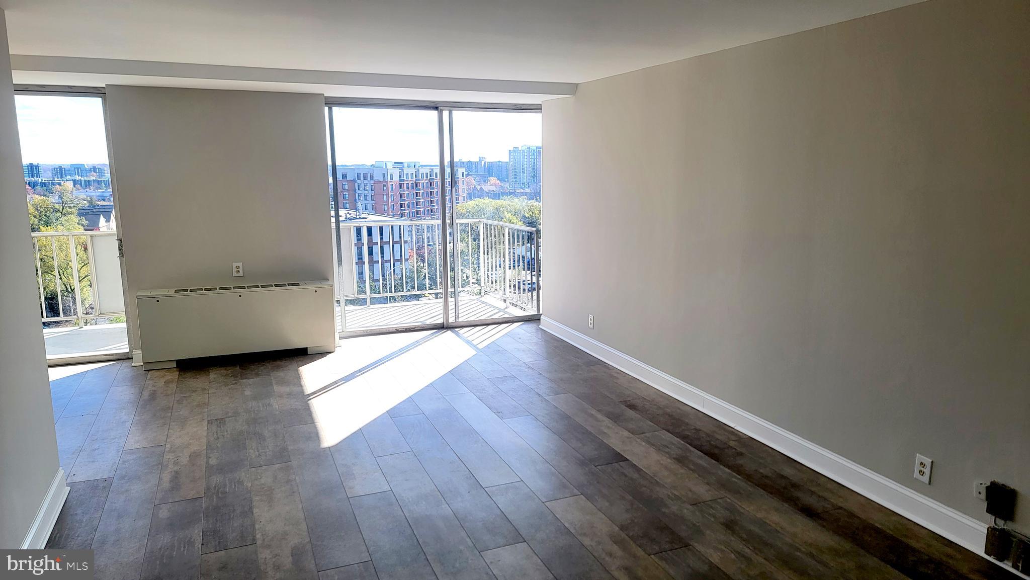 301 North Beauregard Street, Unit 903 Alexandria, VA 22312 - Photo 6 of 19 an empty room with wooden floor and windows