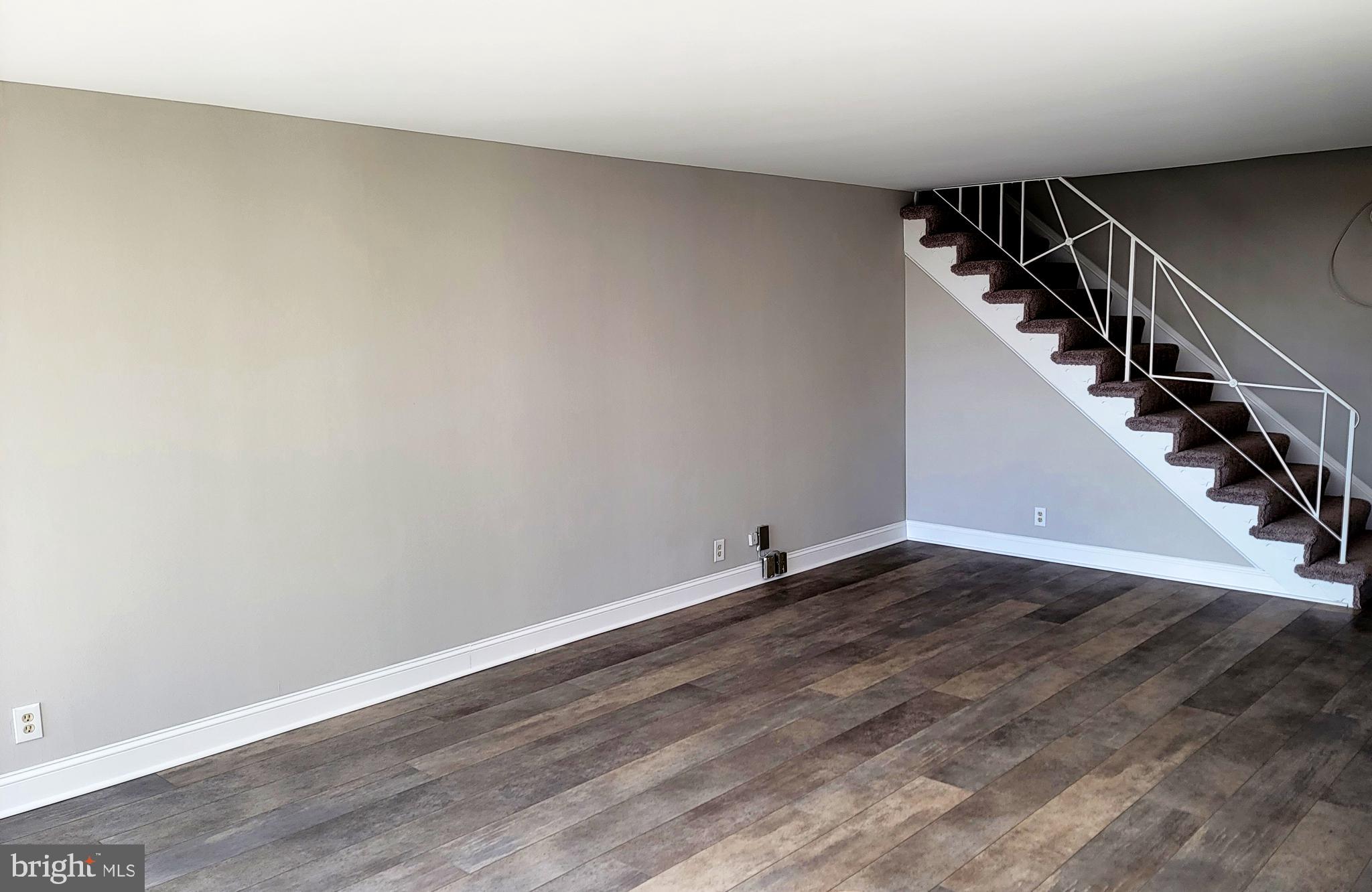 301 North Beauregard Street, Unit 903 Alexandria, VA 22312 - Photo 8 of 19 a view of an empty room with wooden floor and stairs