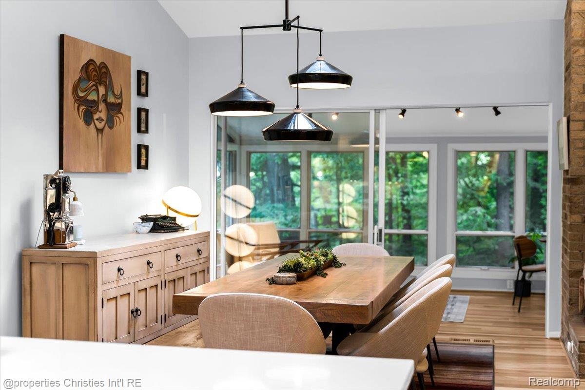 3939 Charing Cross Road Bloomfield Hills, MI 48304 - Photo 17 of 33 Spacious dining area featuring a vaulted ceiling and a linear chandelier with three dome pendants