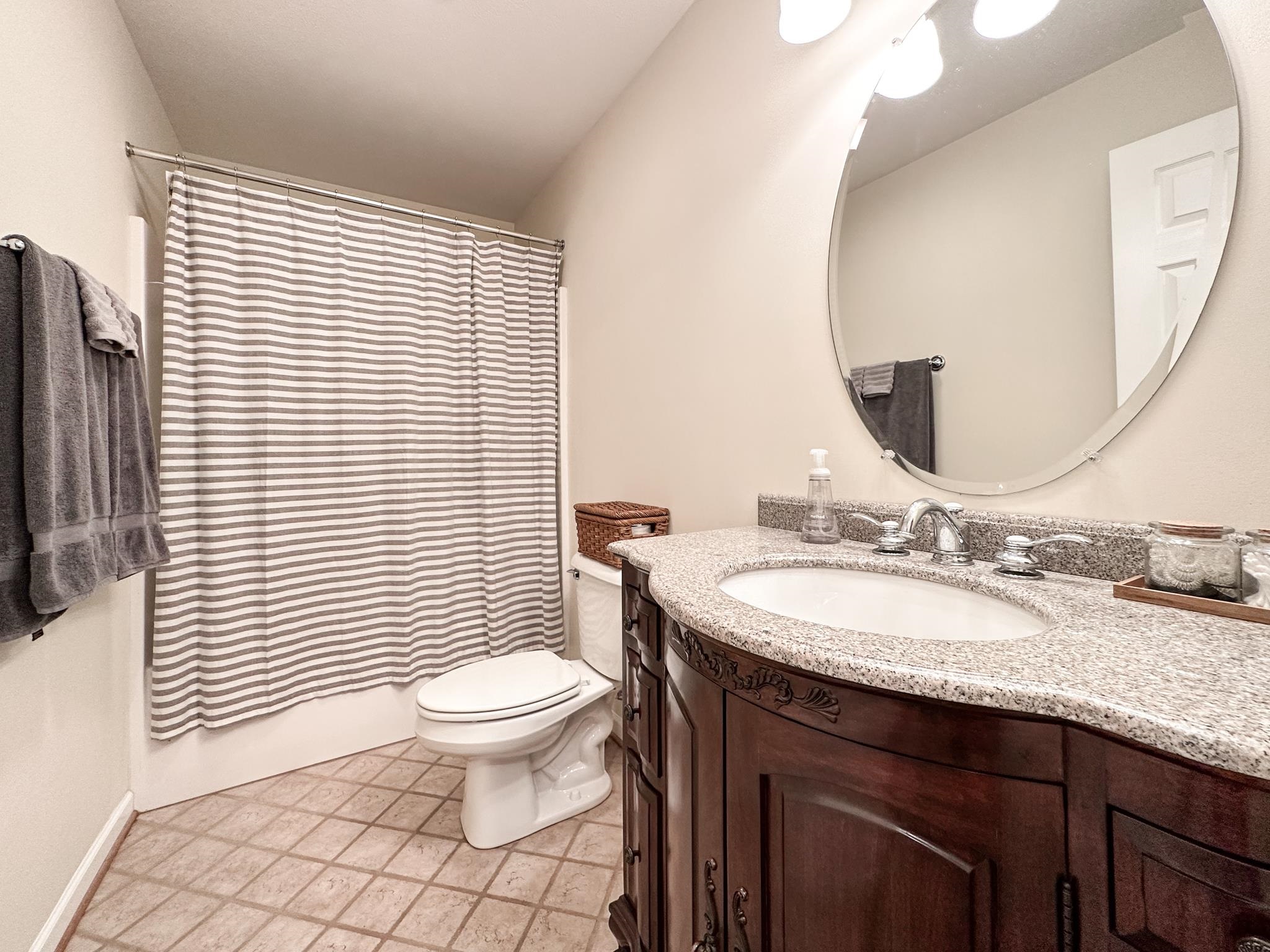 30 Fox Crest Ridge Staunton, VA 24401 - Photo 29 of 31 a bathroom with a granite countertop toilet a sink a mirror and a window