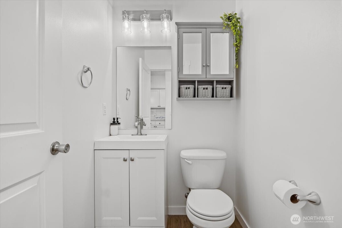 4333 Northwest Commons Drive Pasco, WA 99301 - Photo 15 of 25 a bathroom with a toilet a sink and mirror