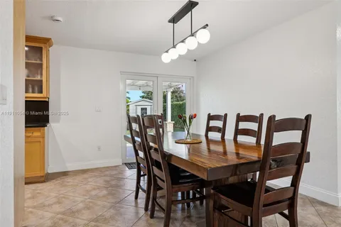 a kitchen with stainless steel appliances granite countertop a refrigerator a sink dishwasher a stove and white cabinets