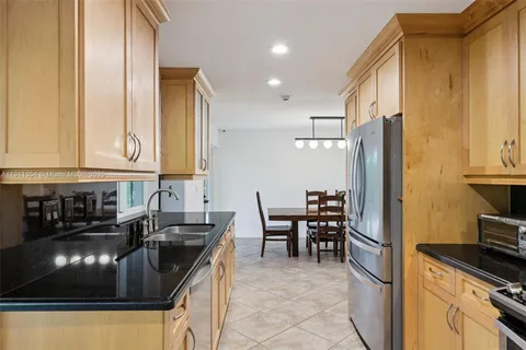 a kitchen with granite countertop a stove and a sink