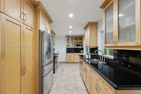 a kitchen with stainless steel appliances granite countertop a stove and a sink