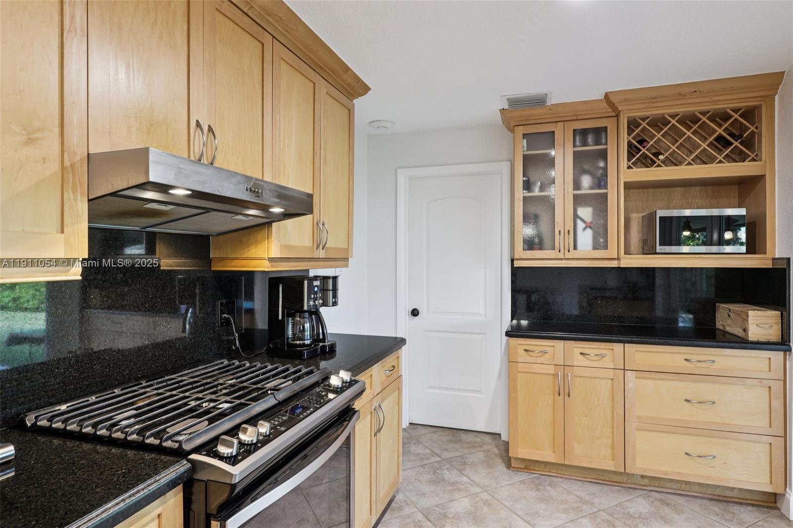 6721 Southwest 135th Avenue Miami, FL 33183 - Photo 17 of 66 a kitchen with granite countertop a stove and a sink