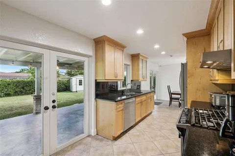 a large white bed sitting in a room next to a window