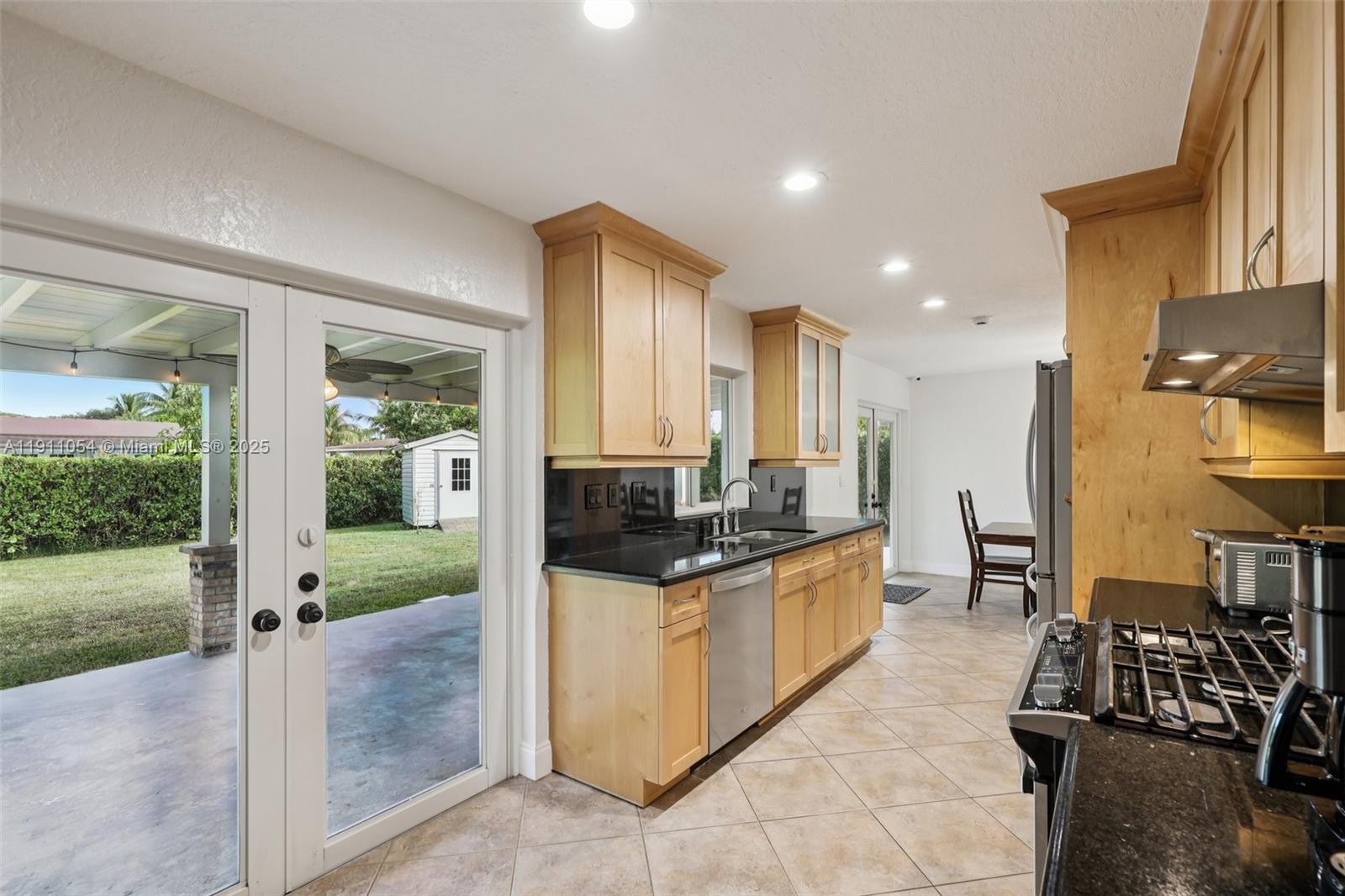 6721 Southwest 135th Avenue Miami, FL 33183 - Photo 18 of 66 a kitchen with stainless steel appliances granite countertop a stove and a sink