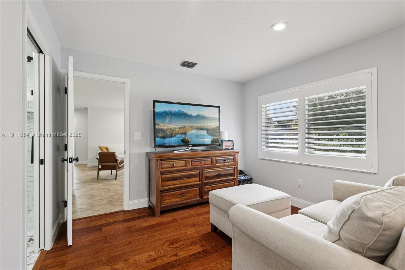 6721 Southwest 135th Avenue Miami, FL 33183 - Photo 22 of 66 a living room with furniture and a flat screen tv