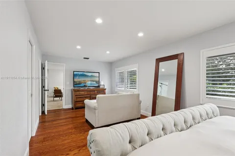 a bedroom with a bed and a book shelf