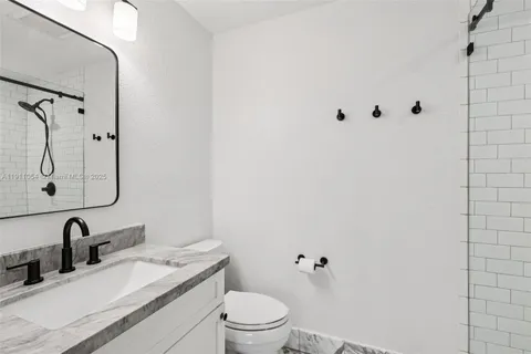 a bedroom with a bed and a dresser in it