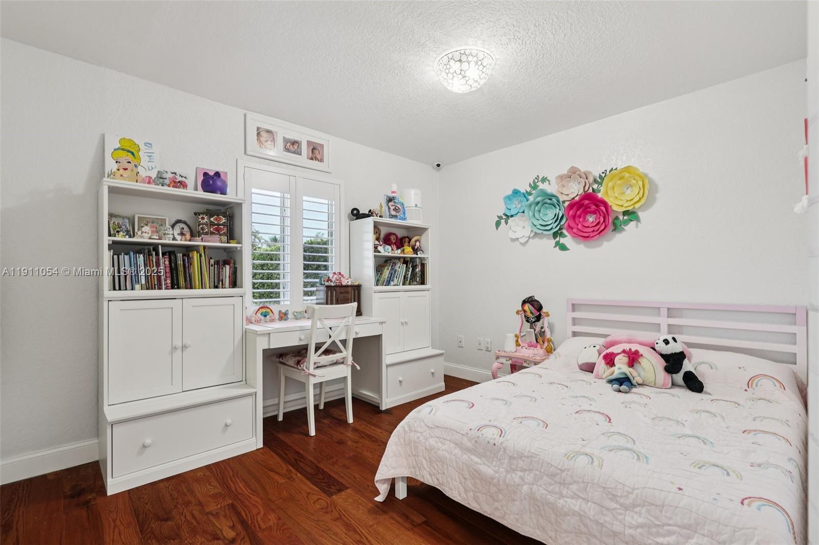 6721 Southwest 135th Avenue Miami, FL 33183 - Photo 30 of 66 a bedroom with a bed and a book shelf