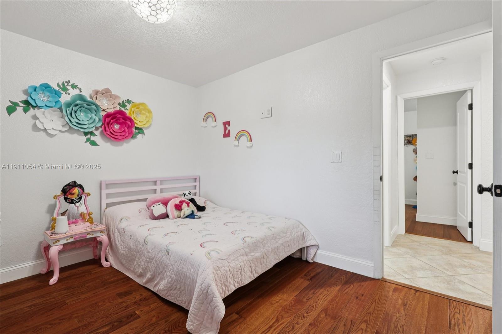 6721 Southwest 135th Avenue Miami, FL 33183 - Photo 31 of 66 a bedroom with a bed a dresser and wooden floor