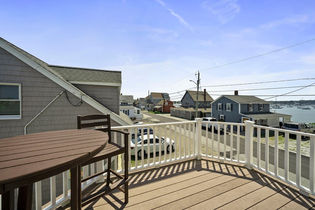 77 Lighthouse Road Scituate, MA 02066 - Photo 27 of 42 a balcony with wooden floor and outdoor seating