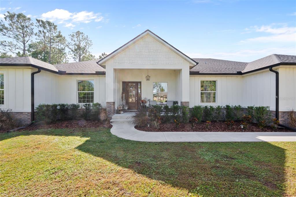 3262 Pheasant Trail Mims, FL 32754 - Photo 1 of 79 a view of a house with backyard and sitting area