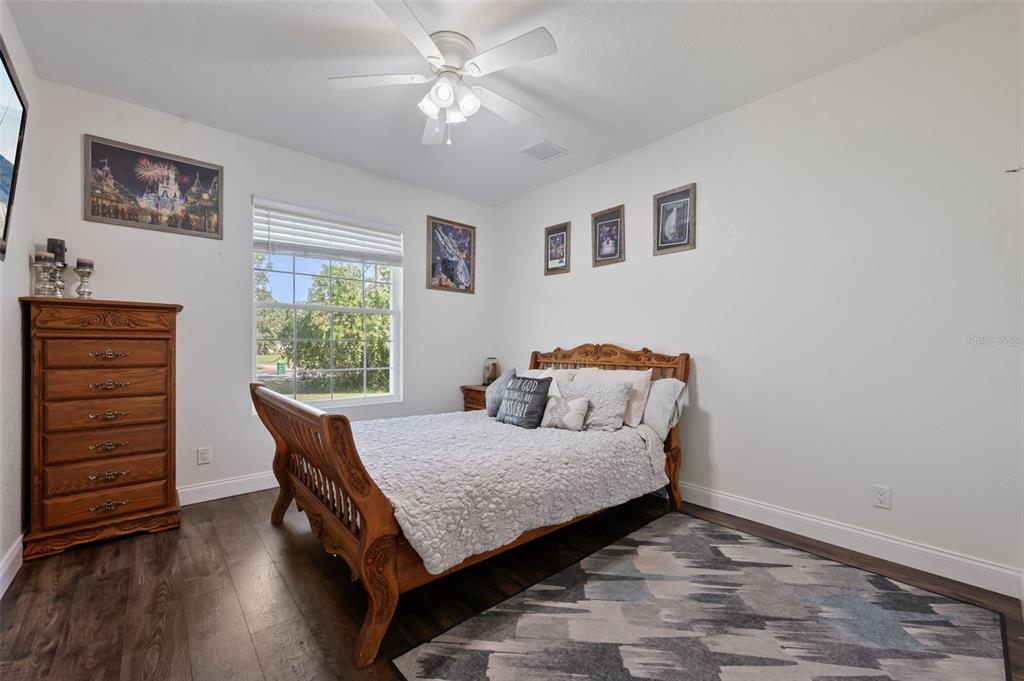 3262 Pheasant Trail Mims, FL 32754 - Photo 27 of 79 a bedroom with a bed and a dresser