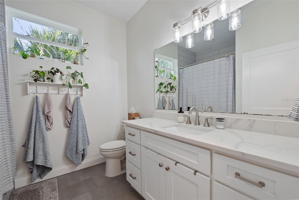 3262 Pheasant Trail Mims, FL 32754 - Photo 28 of 79 a bathroom with a sink a toilet and a mirror
