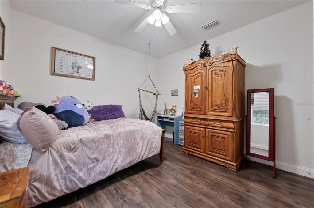 3262 Pheasant Trail Mims, FL 32754 - Photo 31 of 79 a bedroom with bed and wooden floor