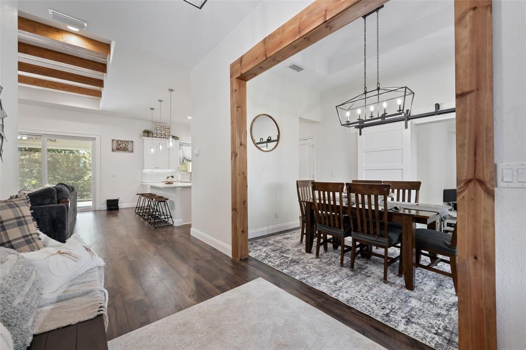 3262 Pheasant Trail Mims, FL 32754 - Photo 34 of 79 a dining room with furniture a chandelier and wooden floor