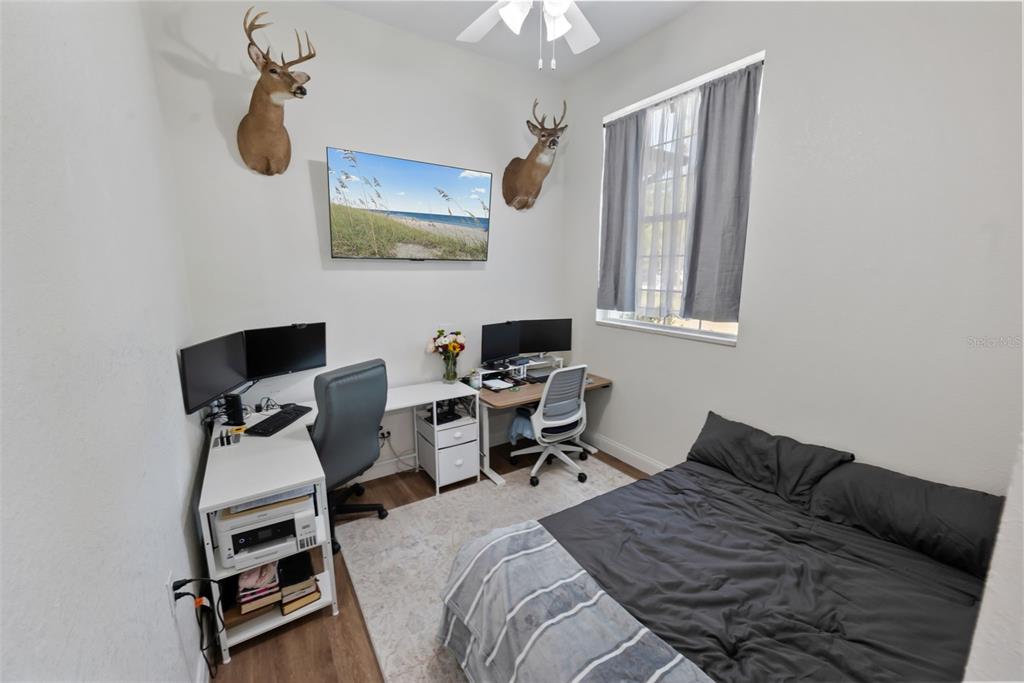 3262 Pheasant Trail Mims, FL 32754 - Photo 38 of 79 a bedroom with bed chair and wall painting