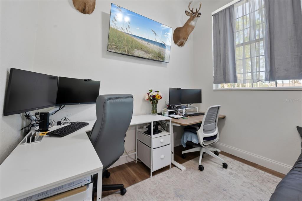 3262 Pheasant Trail Mims, FL 32754 - Photo 39 of 79 a view of a workspace with furniture and a window