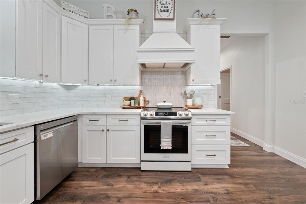 3262 Pheasant Trail Mims, FL 32754 - Photo 42 of 79 a kitchen with stainless steel appliances white cabinets and a sink