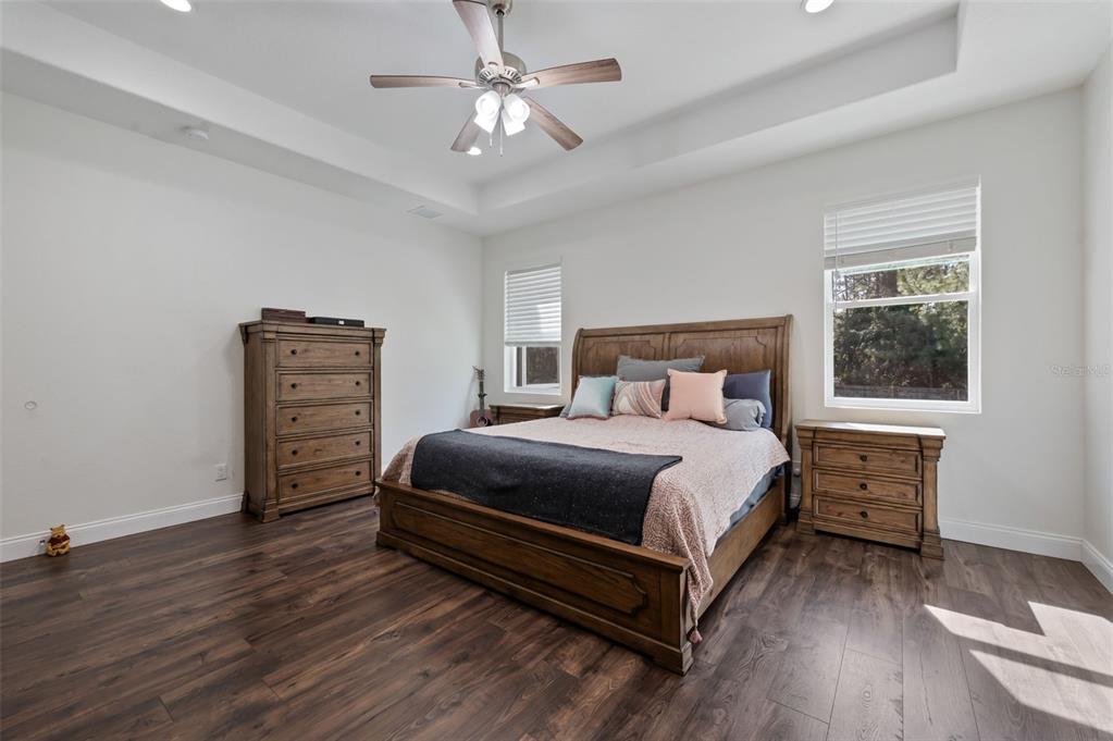 3262 Pheasant Trail Mims, FL 32754 - Photo 60 of 79 a bedroom with a bed and a chandelier