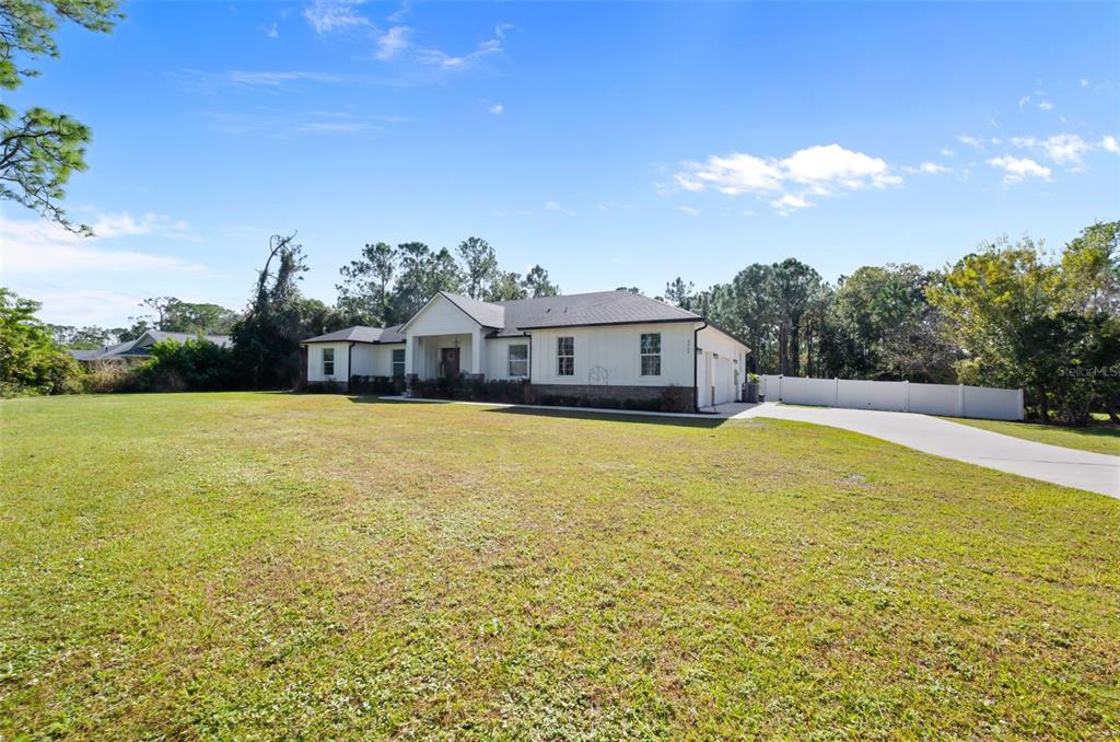 3262 Pheasant Trail Mims, FL 32754 - Photo 65 of 79 a view of a swimming pool with an outdoor seating and a garden