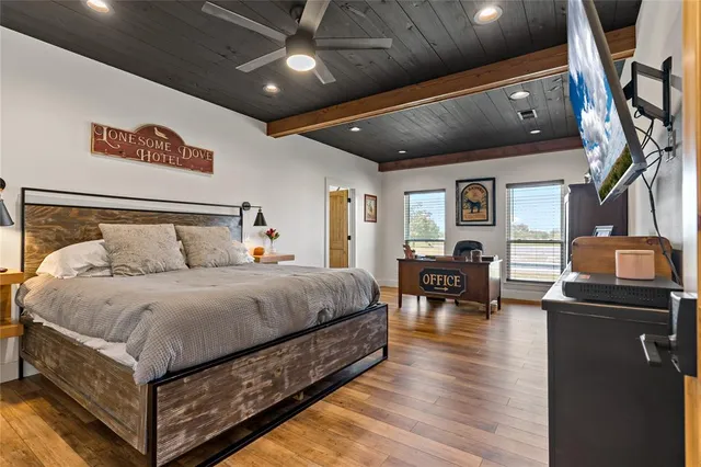 a spacious bedroom with a bed and furniture