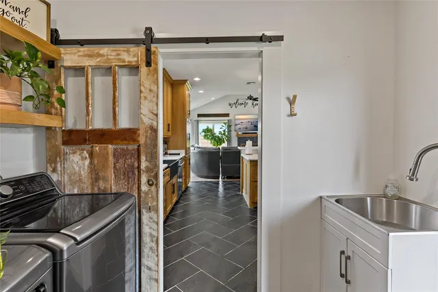 a kitchen with stainless steel appliances granite countertop a refrigerator and a sink