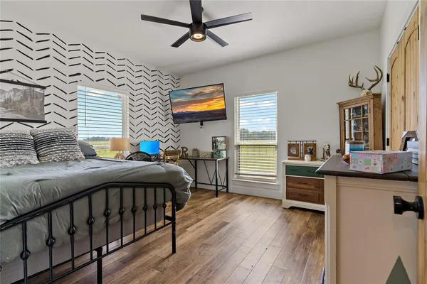 a bedroom with furniture and a wooden floor
