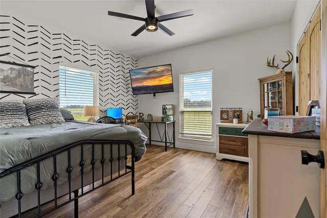 a bedroom with furniture and a wooden floor