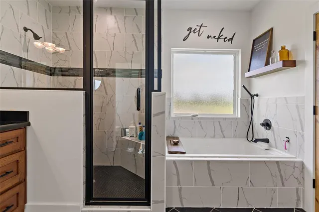 a bathroom with a bathtub and a shower