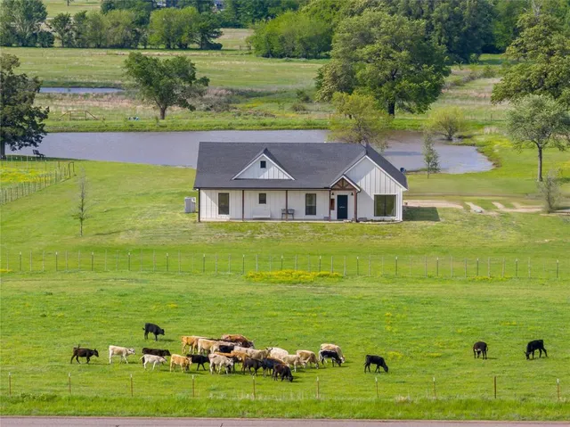 a view of a big yard with an outdoor seating