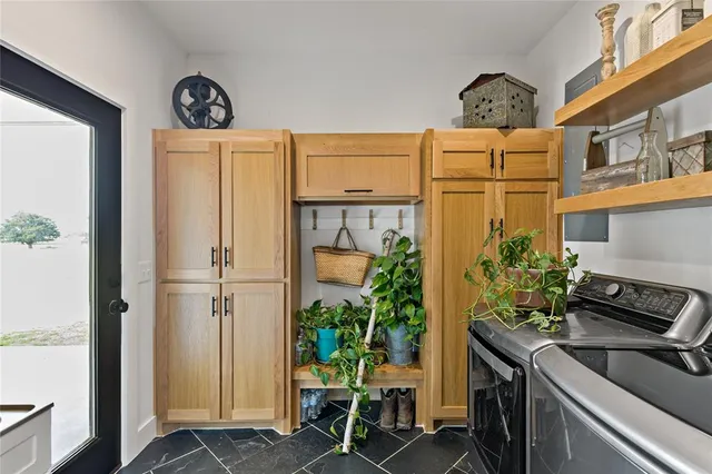 a view of kitchen with furniture and refrigerator
