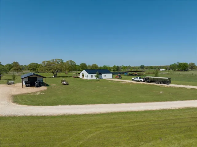 a backyard of a house with barbeque oven table and chairs