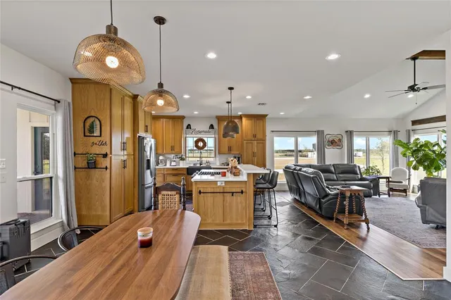 a living room with lots of furniture and kitchen view