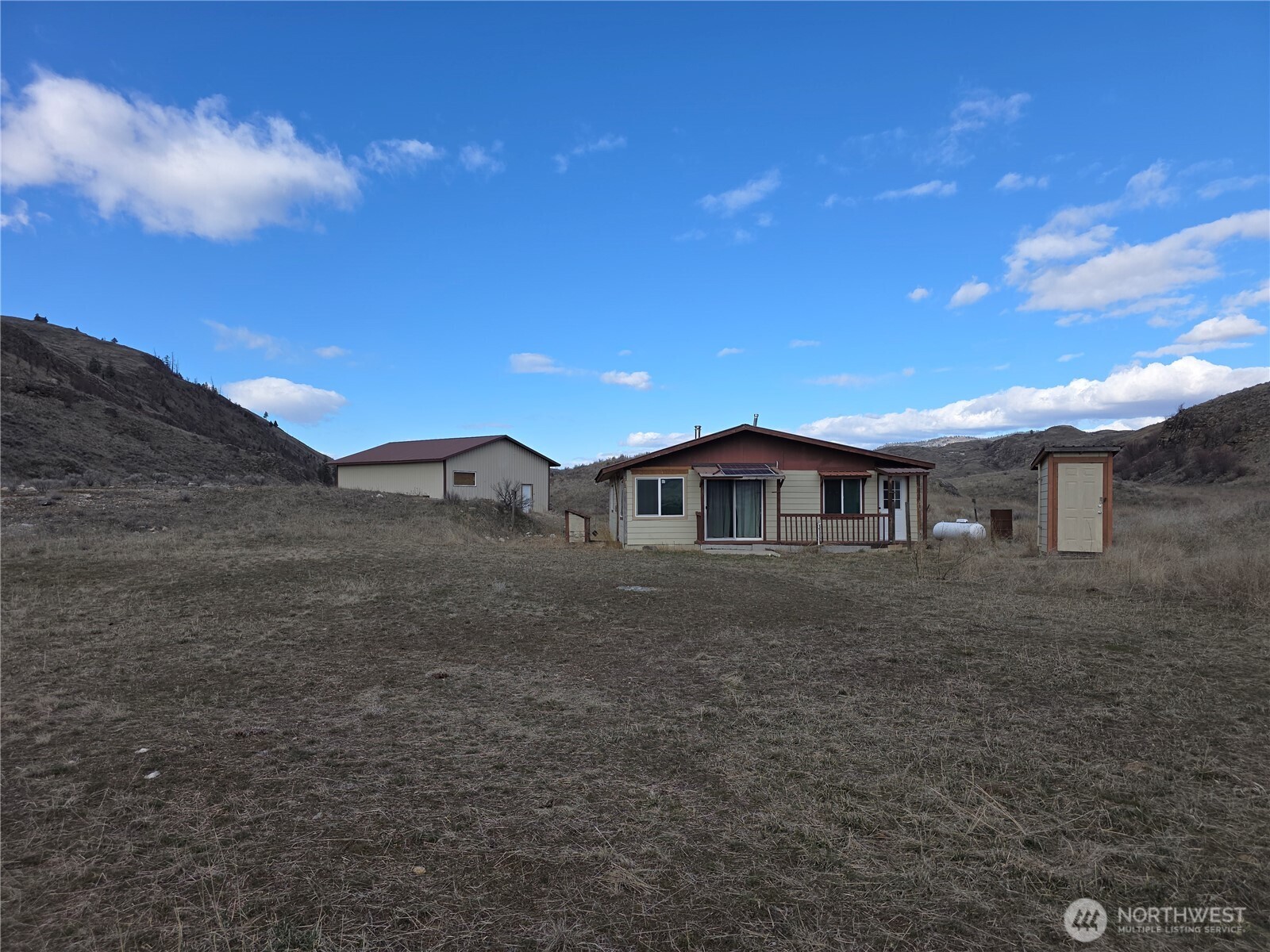 105 Emily Road Oroville, WA 98844 - Photo 14 of 24 a front view of a house with a yard