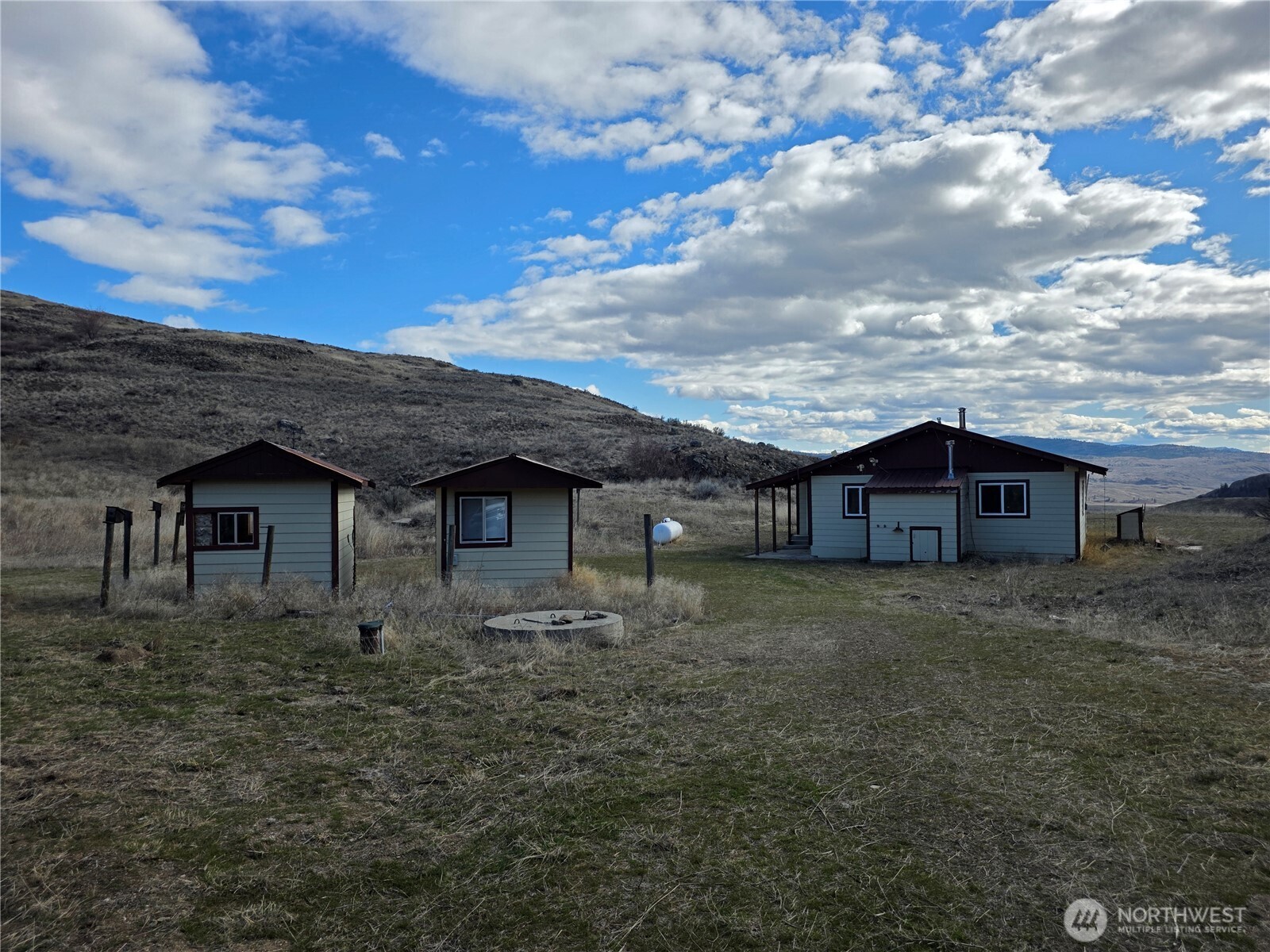 105 Emily Road Oroville, WA 98844 - Photo 3 of 24 front view of a house with a dry yard