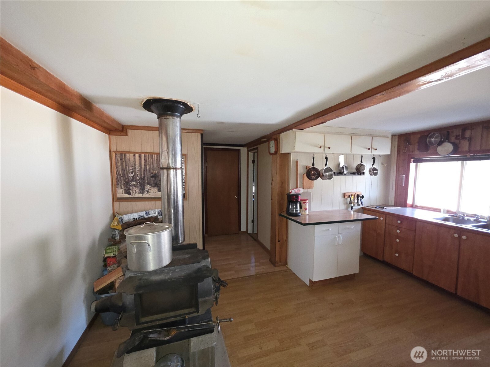 105 Emily Road Oroville, WA 98844 - Photo 10 of 24 a kitchen with sink cabinets and window