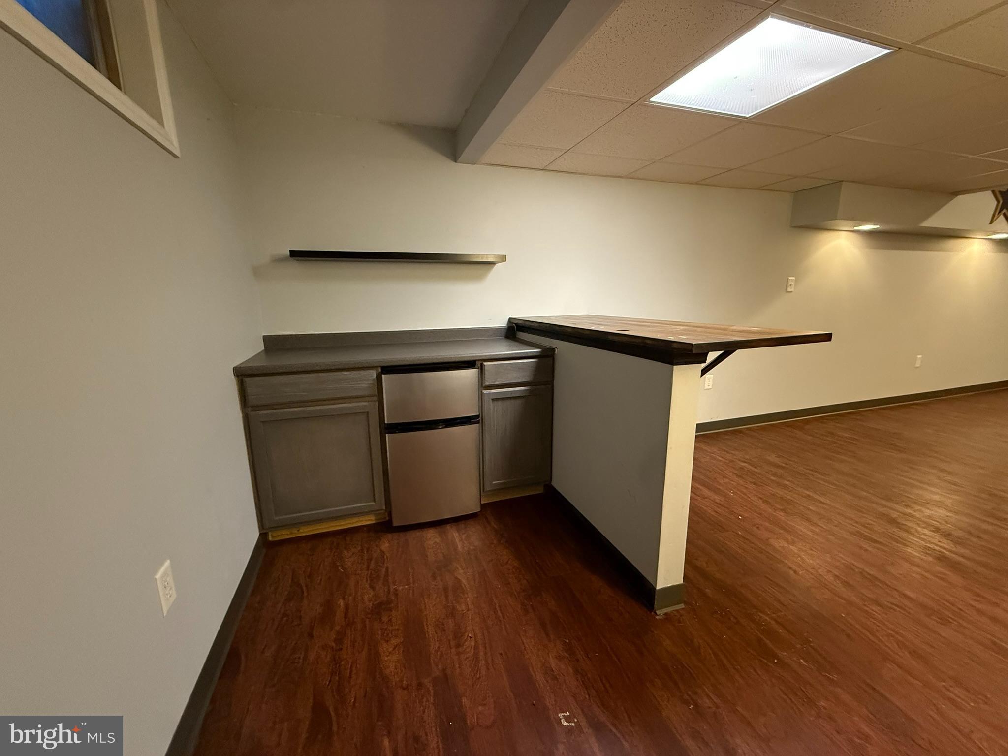60-6 Mint Tier Reading, PA 19606 - Photo 40 of 50 a kitchen with wooden floors and white appliances