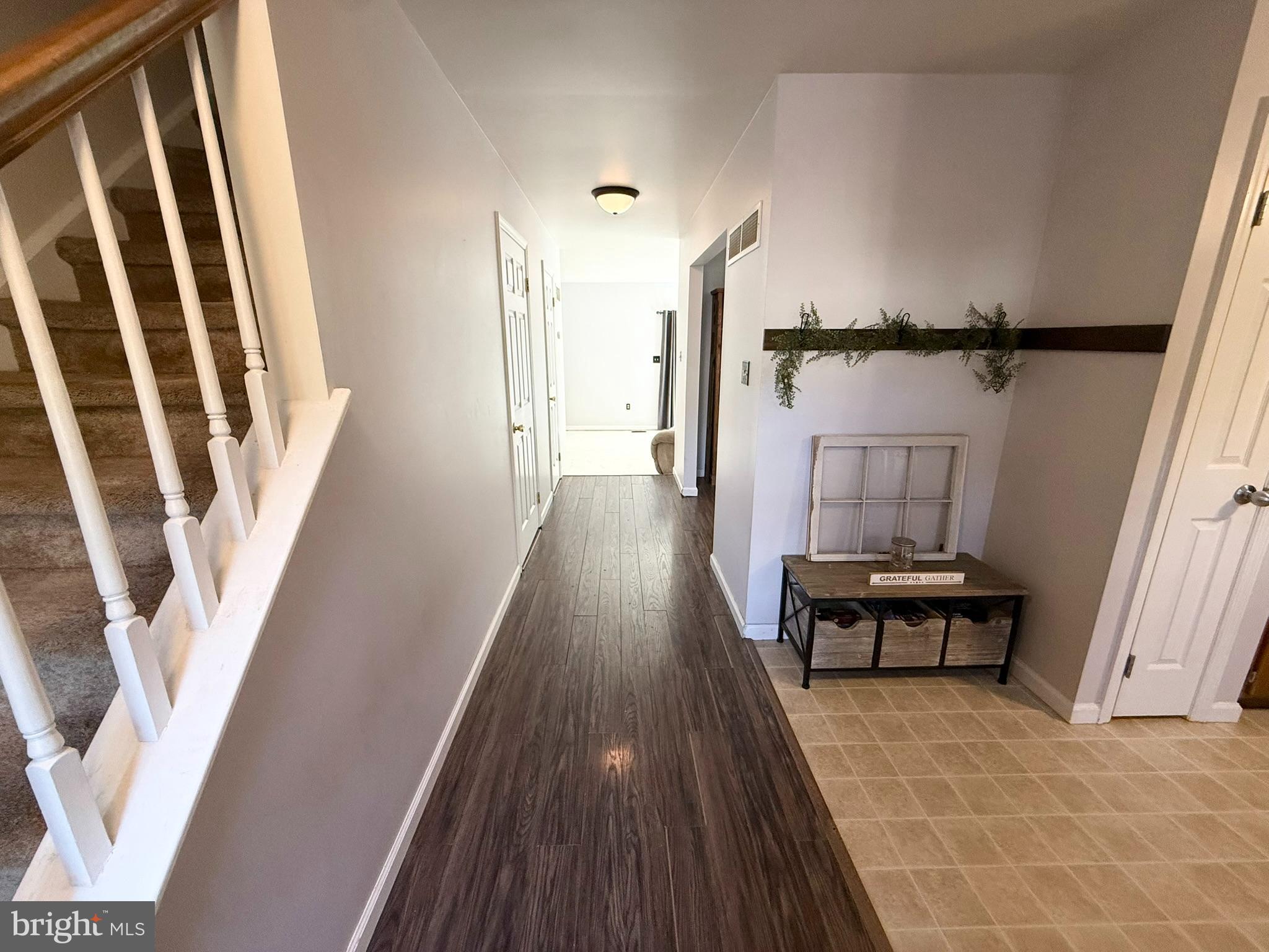 60-6 Mint Tier Reading, PA 19606 - Photo 5 of 50 a view of a hallway with wooden floor and staircase