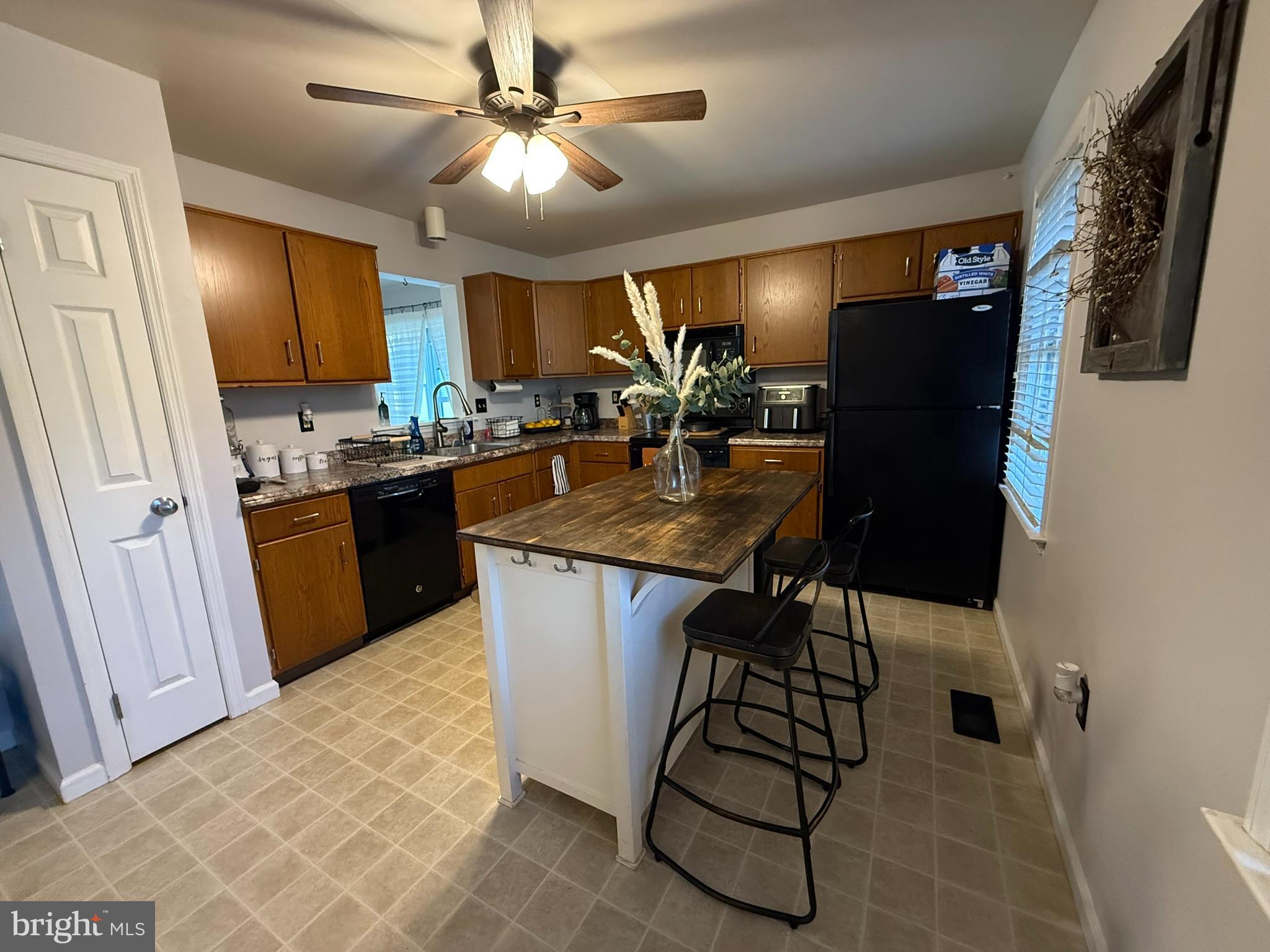 60-6 Mint Tier Reading, PA 19606 - Photo 8 of 50 a kitchen with stainless steel appliances granite countertop a sink a stove a refrigerator a washer dryer and a dining table