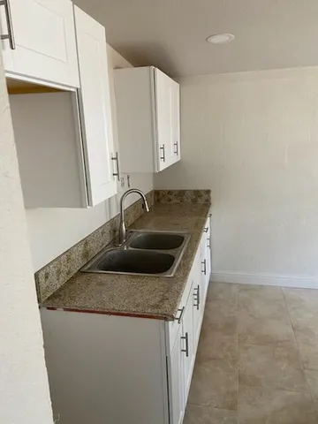 a kitchen with stainless steel appliances granite countertop a sink and dishwasher