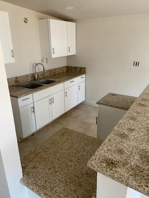 2326 East Hampton Way Fresno, CA 93726 - Photo 3 of 6 a kitchen with granite countertop sink and cabinets