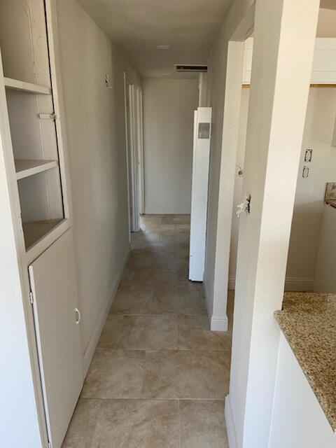 2326 East Hampton Way Fresno, CA 93726 - Photo 4 of 6 view of a hallway with wooden floor and staircase
