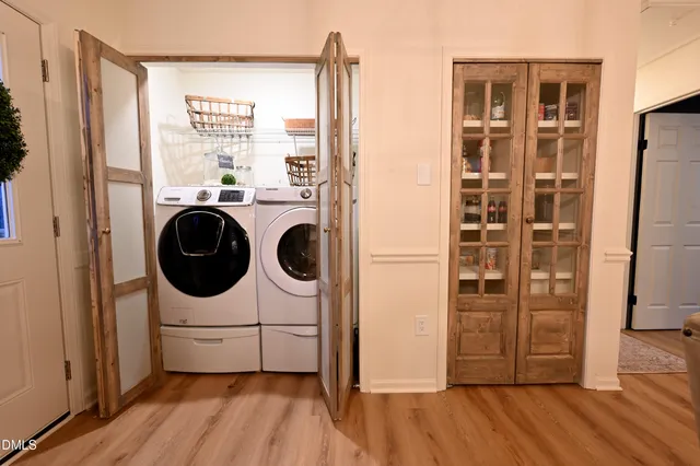 a living room with furniture a rug and a view of kitchen